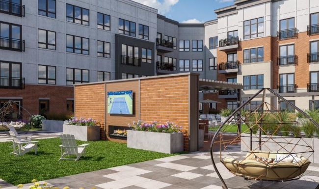 an outdoor patio with a tv and seating options